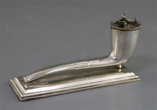 An Edwardian novelty silver table lighter, modelled as a smokers pipe on a rectangular base, 13.4cm.